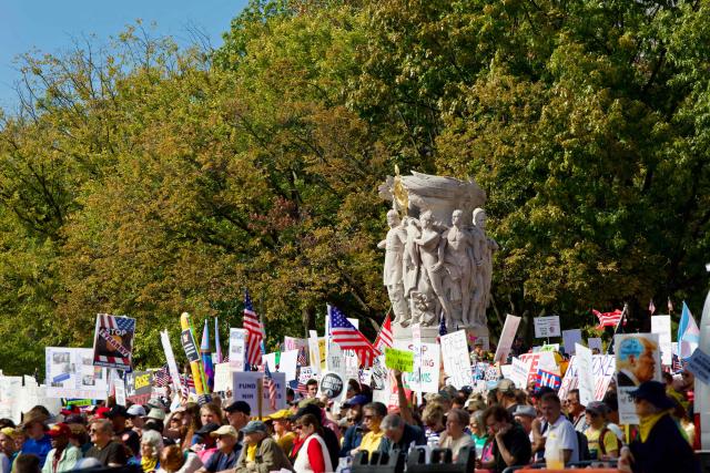 Protesters rally during the "No Kings" national day of protest in Washington, DC on October 18, 2025. From New York to San Francisco, millions of Americans are expected to hit the streets to voice their anger over President Donald Trump's policies at nationwide "No Kings" protests. (Photo by Amid FARAHI / AFP)