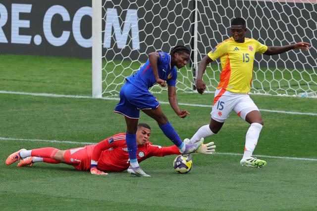 France's midfielder #19 Fode Sylla fights for the ball with Colombia's goalkeeper #01 Jordan Garcia, and Colombia's defender #15 Yeimar Mosquera during the 2025 FIFA U-20 World Cup third place football match between Colombia and France at the National Stadium in Santiago on October 18, 2025. (Photo by Javier TORRES / AFP)