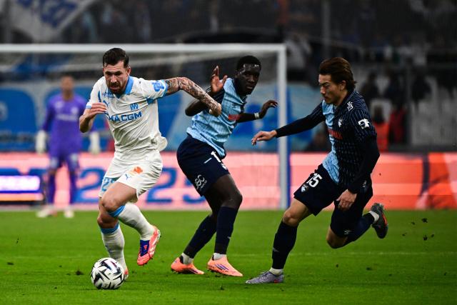 (From L) Marseille's Danish midfielder #23 Pierre-Emile Hojbjerg fights for the ball with Le Havre's Senegalese midfielder #14 Rassoul Ndiaye and Le Havre's Japanese defender #15 Ayumu Seko during the French L1 football match between Olympique de Marseille (OM) and Le Havre AC at the Stade Velodrome in Marseille, southern France, on October 18, 2025. (Photo by Miguel MEDINA / AFP)