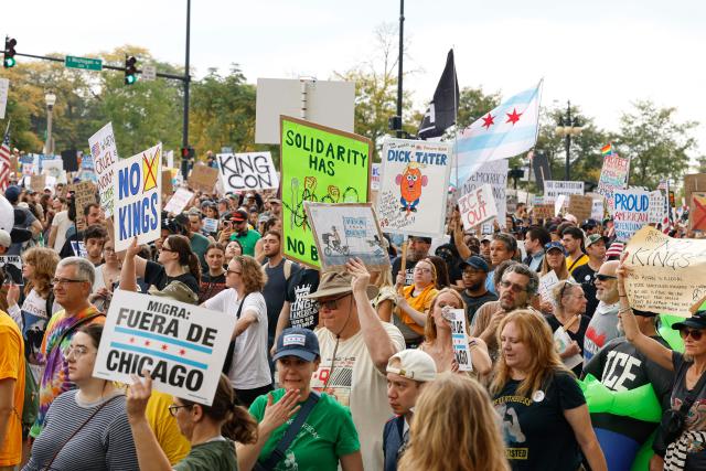 A man rests before a rally during the "No Kings" national day of protest in Chicago on October 18, 2025. From New York to San Francisco, millions of Americans are expected to hit the streets to voice their anger over President Donald Trump's policies at nationwide "No Kings" protests. (Photo by KAMIL KRZACZYNSKI / AFP)