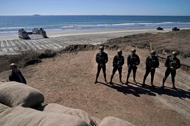Navy Seals perform an amphibious capabilities demonstration as US Vice President JD Vance and US Second Lady Usha Vance visit, on Red Beach at Camp Pendleton, California, on October 18, 2025 as part of the Marine Corps' 250th anniversary celebrations. (Photo by Oliver Contreras / AFP)