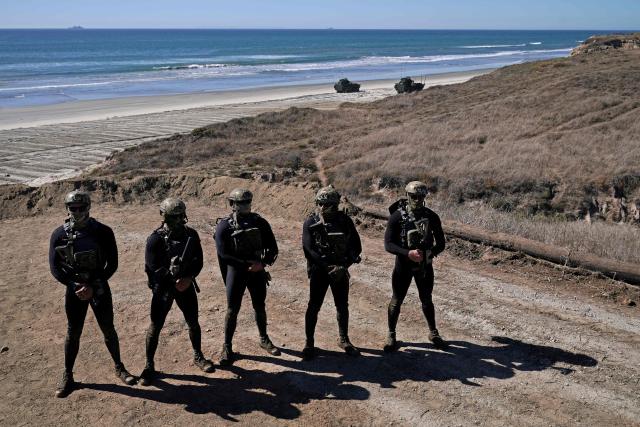 Navy Seals perform an amphibious capabilities demonstration as US Vice President JD Vance and US Second Lady Usha Vance visit, on Red Beach at Camp Pendleton, California, on October 18, 2025 as part of the Marine Corps' 250th anniversary celebrations. (Photo by Oliver Contreras / AFP)