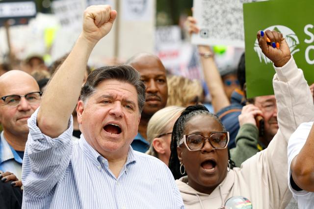 Illinois Governor JB Pritzker (L) attends a rally during the "No Kings" national day of protest in XX on October 18, 2025. From New York to San Francisco, millions of Americans are expected to hit the streets to voice their anger over President Donald Trump's policies at nationwide "No Kings" protests. (Photo by KAMIL KRZACZYNSKI / AFP)