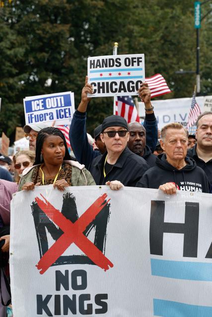 US actor John Cusack (C) attends a rally during the "No Kings" national day of protest in XX on October 18, 2025. From New York to San Francisco, millions of Americans are expected to hit the streets to voice their anger over President Donald Trump's policies at nationwide "No Kings" protests. (Photo by KAMIL KRZACZYNSKI / AFP)