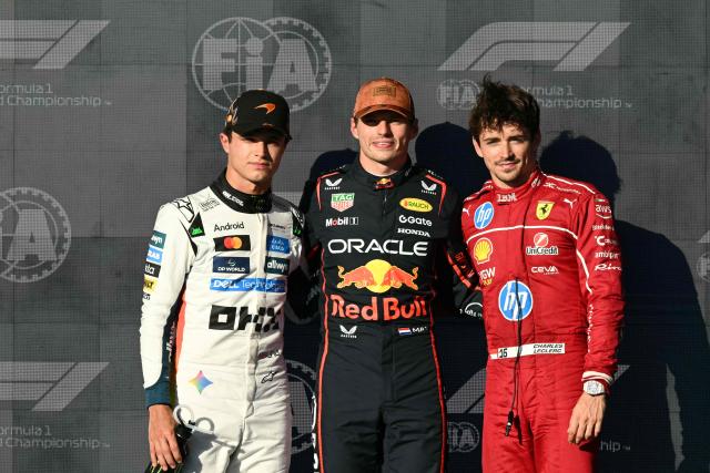 Red Bull Racing's Dutch driver Max Verstappen (C), winner of the pole position, stands alongside McLaren's British driver Lando Norris (L), second place, and Ferrari's Monegasque driver Charles Leclerc (R), third place, at the end of the qualifying session for the United States Formula One Grand Prix at the Circuit of the Americas in Austin, Texas, on October 18, 2025. (Photo by RONALDO SCHEMIDT / AFP)