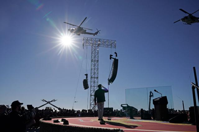 US Vice President JD Vance salutes as helicopters fly over as part of the Marine Corps' 250th anniversary celebration at Camp Pendleton, California, on October 18, 2025. (Photo by Oliver Contreras / AFP)