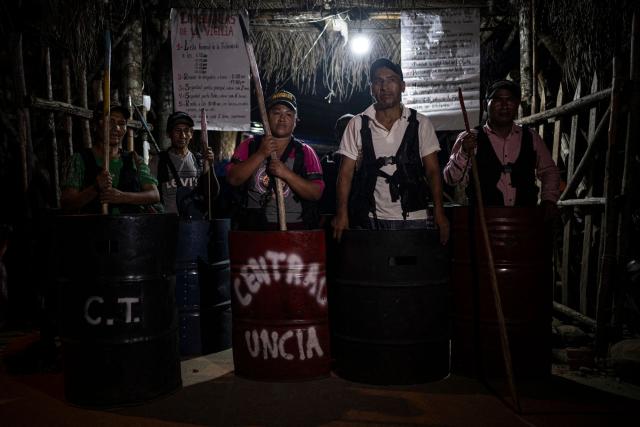 Members of the guard that protects former Bolivian president Evo Morales attend a meeting in Lauca Ene, headquarters of the coca growers movement in Chapare province, Bolivia on October 18, 2025. Bolivia chooses between two pro-business candidates in presidential elections on Sunday, ending two decades of socialist rule that have left the beleaguered South American nation deep in economic crisis. (Photo by Ernesto BENAVIDES / AFP)