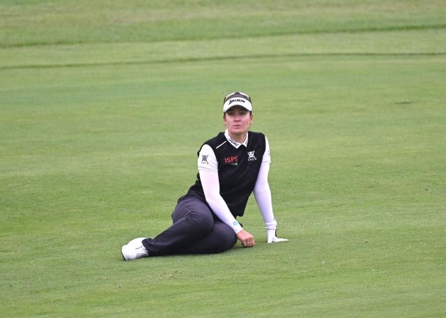 Hannah Green of Australia sits on the fairway as she waits for her turn on the 2nd hole during the final round of the LPGA Tour - BMW Ladies Championship golf tournament at Pine Beach Golf Links in Haenam on October 19, 2025. (Photo by Jung Yeon-je / AFP)