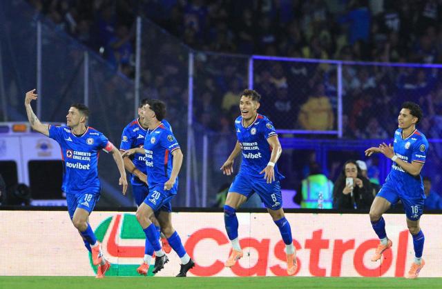 Cruz Azul's Uruguayan midfielder #15 Ignacio Rivero (L) celebrates with teammates after scoring his team's second goal during the Liga MX Apertura football tournament match between Cruz Azul and america at the Olimpico Universitario Stadium in Mexico City on October 18, 2025. (Photo by Victor CRUZ / AFP)