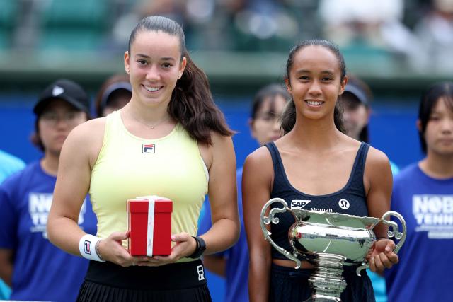 Canada's Leylah Fernandez (R) holds the winner's trophy while posing with runner-up Czech Republic's Tereza Valentova following their women's singles final match at the Japan Open tennis tournament in Osaka on October 19, 2025. (Photo by PAUL MILLER / AFP)