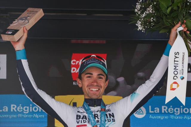 (FILES) Bahrain Victorious's French rider Lenny Martinez celebrates winning the stage on the podium of the 8th and final stage of the 77th edition of the Criterium du Dauphine cycling race, 133,3 km between Val-d'Arc and Val-Cenis - Plateau du Mont Cenis, on June 15, 2025. French climber Lenny Martinez ended the season in style by winning the Japan Cup solo on October 19, 2025 in Utsunomiya. The 22-year-old Cannes rider has won three World Tour races this year, winning a stage at Paris-Nice, the Tour de Romandie and the Critérium du Dauphiné. (Photo by Anne-Christine POUJOULAT / AFP)