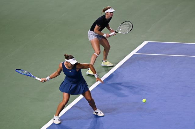 USA's Nicole Melichar-Martinez (Bottom) and Russia’s Liudmila Samsonova play a point against Hungary's Timea Babos and Brazil's Luisa Stefani during their women’s doubles final match at the WTA Ningbo Open tennis tournamen in Ningbo, in China’s eastern Zhejiang province on October 19, 2025. (Photo by AFP) / China OUT