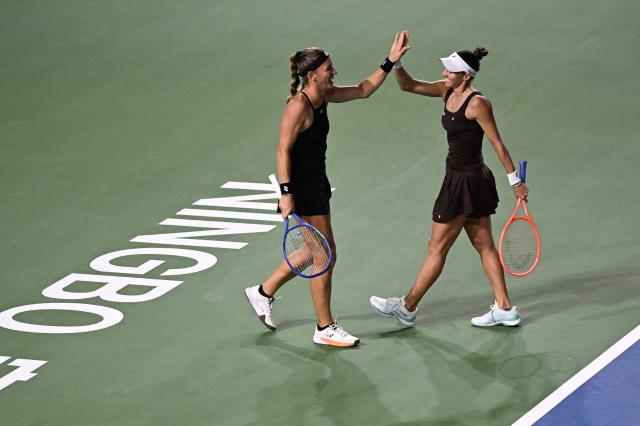 Hungary's Timea Babos (L) and Brazil's Luisa Stefani react during their women’s doubles final match against USA's Nicole Melichar-Martinezand Russia’s Liudmila Samsonova at the WTA Ningbo Open tennis tournamen in Ningbo, in China’s eastern Zhejiang province on October 19, 2025. (Photo by AFP) / China OUT
