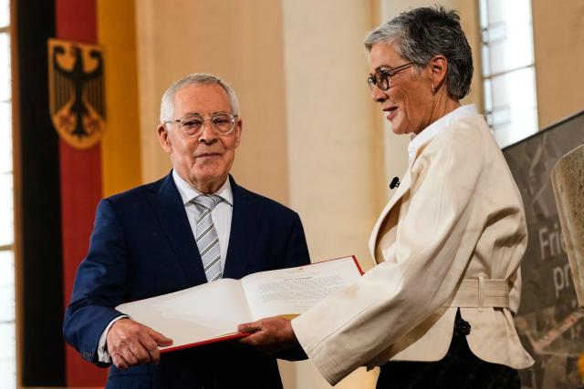 German historian and essayist Karl Schloegel (L) is awarded the Peace Prize of the German Book Trade by Karin Schmidt-Friderichs, president of the German Publishers and Booksellers Association, at Paulskirche (St Paul's Church) in Frankfurt am Main, western Germany, on October 19, 2025. (Photo by Michael Probst / POOL / AFP)