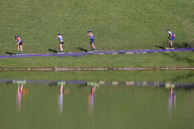Women on roller skis warm up for the qualifying of the new Biathlon Opening Festival "LOOP ONE" at the Olympiapark in Munich, southern Germany, on October 19, 2025. (Photo by Michaela STACHE / AFP)