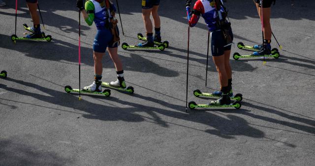 Women wait for the start of the qualifying of the new Biathlon Opening Festival "LOOP ONE" at the Olympiapark in Munich, southern Germany, on October 19, 2025. (Photo by Michaela STACHE / AFP)