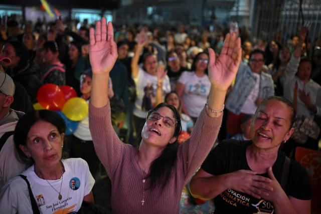 Catholic faithfuls gather at La Candelaria Square to attend the canonization ceremony of Venezuelan doctor Jose Gregorio Hernandez and Venezuelan Sister Maria Rendiles in Caracas on October 19, 2025. (Photo by Federico PARRA / AFP)
