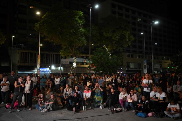 Catholic faithfuls gather at La Candelaria Square to attend the canonization ceremony of Venezuelan doctor Jose Gregorio Hernandez and Venezuelan Sister Maria Rendiles in Caracas on October 19, 2025. (Photo by Federico PARRA / AFP)