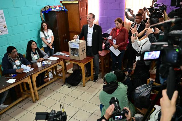 Bolivia's former president and presidential candidate for the Freedom and Democracy (Libre) alliance, Jorge "Tuto" Quiroga, casts his vote at a polling station during the presidential runoff election in La Paz, Bolivia, on October 19, 2025. Bolivians head to the polls to choose between right-wing candidates Jorge 'Tuto' Quiroga and Senator Rodrigo Paz, both promising change as the country of some 12 million people sees the end of two decades of socialist rule. (Photo by MARTIN BERNETTI / AFP)