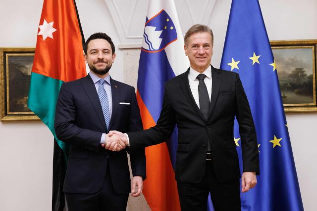 Slovenian Prime Minister Robert Golob (R) and Jordan's Crown Prince Hussein shake hands during their meeting in Brdo pri Kranju, on October 19, 2025. (Photo by Luka Dakskobler / AFP)