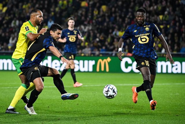 Nantes' Moroccan forward #19 Youssef El-Arabi (L) fights for the ball with Lille's French midfielder #21 Benjamin Andre (2nd L) during the French L1 football match between FC Nantes and Lille LOSC at the Stade de la Beaujoire–Louis Fonteneau in Nantes, western France, on October 19, 2025. (Photo by Sebastien Salom-Gomis / AFP)