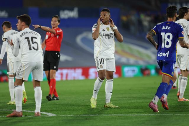 Real Madrid's French forward #10 Kylian Mbappe reacts after failing a goal opportunity during the Spanish league football match between Getafe CF and Real Madrid CF at Coliseum Alfonso Perez Stadium in Getafe on October 19, 2025. (Photo by Thomas COEX / AFP)