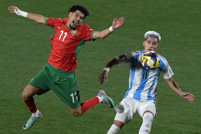 Morocco's forward #11 Ilias Boumassaoudi and Argentina's forward #11 Ian Subiabre fight for the ball during the 2025 FIFA U-20 World Cup final football match between Argentina and Morocco at the National Stadium in Santiago on October 19, 2025. (Photo by Rodrigo ARANGUA / AFP)