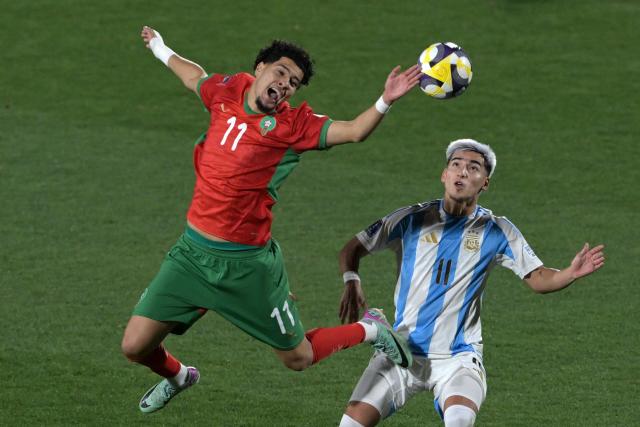 Morocco's forward #11 Ilias Boumassaoudi and Argentina's forward #11 Ian Subiabre fight for the ball during the 2025 FIFA U-20 World Cup final football match between Argentina and Morocco at the National Stadium in Santiago on October 19, 2025. (Photo by Rodrigo ARANGUA / AFP)