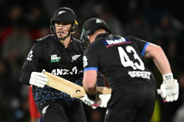 New Zealand's Mark Chapman (L) and Tim Seifert run between the wickets during the second Twenty20 international cricket match between New Zealand and England at Hagley Oval in Christchurch on October 20, 2025. (Photo by Sanka VIDANAGAMA / AFP)