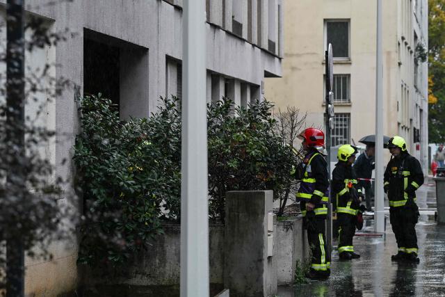 Firefighters work at the site following a fire in a residential building in Lyon on October 20, 2025. Four people died on October 20, 2025 in a fire in a ten-story building in Lyon's 3rd arrondissement, which broke out at around 5:10 a.m., according to the Rhône prefecture. The fire was extinguished around 7:00 a.m. Ten other people were examined by emergency services, and a gymnasium was opened by the city of Lyon to accommodate those involved, authorities said. (Photo by JEAN-PHILIPPE KSIAZEK / AFP)