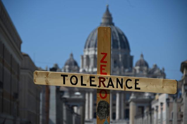 (FILES) A wooden cross reads 'Tolerance Zero' with St Peter's basilica in the background during a protest of activists of Ending Child Abuse (ECA) against paedophilia within the Catholic Church, ahead of Papal Synod in Rome, on September 27, 2023. Pope Leo XIV held his first meeting on October 20, 2025 with an international association of clerical abuse survivors, particpants said, describing it as a "free-flowing" discussion about what the Church should do. "Our goal was to establish a relationship with him and to get a commitment to ongoing discussion, and he was open to both," Tim Law, co-founder of Ending Clergy Abuse (ECA) told AFP after the meeting. (Photo by Filippo MONTEFORTE / AFP)