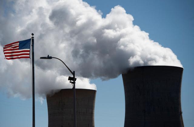 (FILES) Steam rises out of the nuclear plant on Three Mile Island, with the operational plant run by Exelon Generation, in Middletown, Pennsylvania, on March 26, 2019. The agency responsible for safeguarding the US nuclear stockpile began placing the vast majority of its staff on enforced leave on October 20, 2025, US media reported, as the government shutdown dragged into a fourth week. Some 1,400 workers at the National Nuclear Security Administration (NNSA) were due to receive notices telling them they had been placed on unpaid "furlough," CNN reported, leaving fewer than 400 at their posts. (Photo by Andrew CABALLERO-REYNOLDS / AFP)