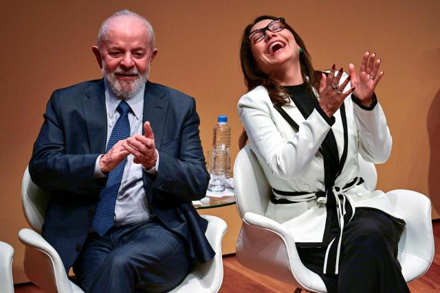 (FILES) Brazilian President Luiz Inacio Lula da Silva and his wife, First Lady Rosangela "Janja" da Silva, applaud during the inauguration ceremony of the new president of Petrobras, Magda Chambriard, in Rio de Janeiro, Brazil, on June 19, 2024. Just days before the COP30 climate summit in Brazil, Petrobras announced on October 20, 2025, that it had received authorization from environmental agency Ibama to begin oil drilling 500 km from the mouth of the Amazon River—a move that has sparked tensions between President Lula’s government and environmentalists. (Photo by Pablo PORCIUNCULA / AFP)