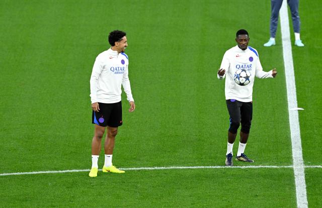 Paris Saint-Germain's French forward #10 Ousmane Dembele and Paris Saint-Germain's Brazilian defender #05 Marquinhos (L) attend a training session on the eve of the UEFA Champions League league phase football match between Bayer 04 Leverkusen and Paris Saint-Germain (PSG) at the BayArena stadium in Leverkusen, western Germany on October 20, 2025. (Photo by Ina FASSBENDER / AFP)