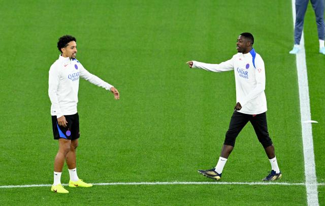 Paris Saint-Germain's French forward #10 Ousmane Dembele and Paris Saint-Germain's Brazilian defender #05 Marquinhos (L) attend a training session on the eve of the UEFA Champions League league phase football match between Bayer 04 Leverkusen and Paris Saint-Germain (PSG) at the BayArena stadium in Leverkusen, western Germany on October 20, 2025. (Photo by Ina FASSBENDER / AFP)