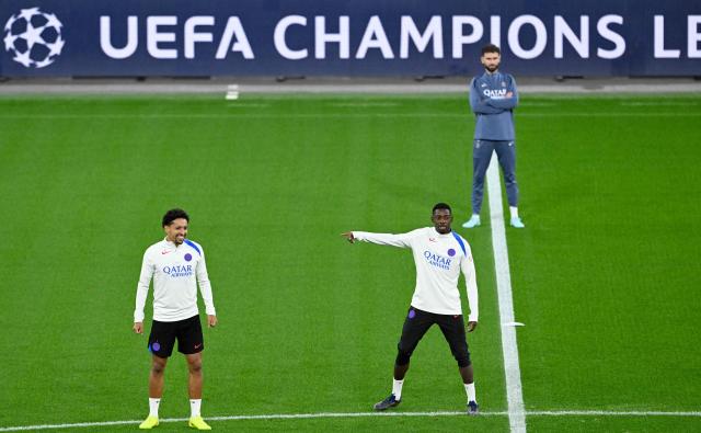 Paris Saint-Germain's French forward #10 Ousmane Dembele and Paris Saint-Germain's Brazilian defender #05 Marquinho (R) attend a training session on the eve of the UEFA Champions League league phase football match between Bayer 04 Leverkusen and Paris Saint-Germain (PSG) at the BayArena stadium in Leverkusen, western Germany on October 20, 2025. (Photo by Ina FASSBENDER / AFP)