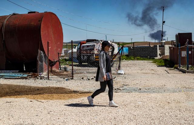 (FILES) Frenchwoman Emilie Konig walks in northeastern Syria's northeastern Syria's Camp Al-Roj on March 28, 2021 where she is held with others suspected of being relatives of alleged members of the Islamic State (IS) group. French jihadist Emilie König was referred to special criminal court, AFP learned from a judicial source on October 20, 2025. (Photo by Delil SOULEIMAN / AFP)