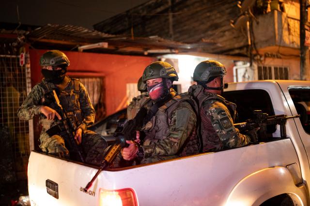 (FILES) Soldiers from the 5th Infantry Brigade go in a pick-up truck during a security operation and search for suspects during the curfew, in a poor neighbourhood of Guayaquil, Ecuador, in the early hours of January 12, 2024. Since 2023, when President Daniel Noboa took office, Amnesty International has documented 43 cases of enforced disappearances carried out by state agents in Ecuador. (Photo by Yuri CORTEZ / AFP)