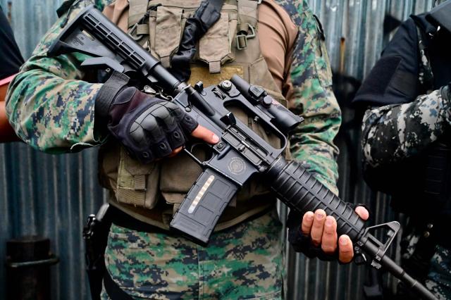 (FILES) A soldier stands guard during a joint armed forces and national police operation in Duran, Ecuador, on March 6, 2025. Since 2023, when President Daniel Noboa took office, Amnesty International has documented 43 cases of enforced disappearances carried out by state agents in Ecuador. (Photo by MARCOS PIN / AFP)