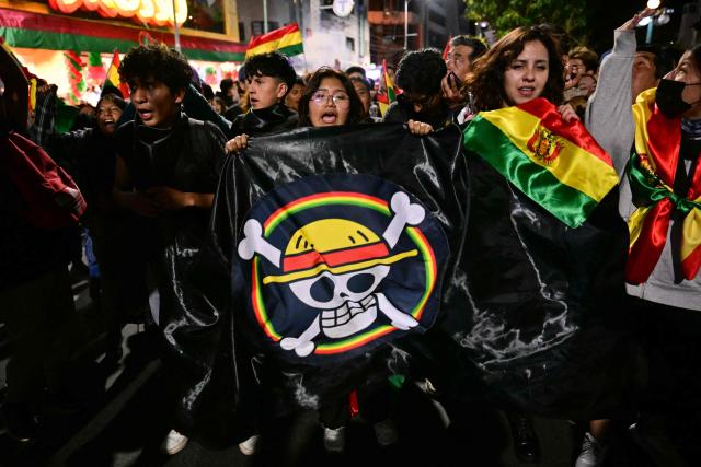 Supporters of Bolivia's former president and presidential candidate for the Freedom and Democracy (Libre) alliance, Jorge "Tuto" Quiroga, holds a One Piece manga flag during a protest following the results of the run-off presidential election in La Paz on October 20, 2025. Bolivians on the eve elected pro-business center-right senator Paz as their new president, ending two decades of socialist rule that have left the South American nation deep in economic crisis. (Photo by MARTIN BERNETTI / AFP)