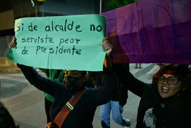 A demonstrator holds a sign that reads "If you failed as mayor, you'll fail even more as president" during a protest against president-elect Rodrigo Paz following the results of the run-off presidential election in La Paz on October 20, 2025. Paz, a 58-year-old economist, won Sunday's election with 54.5% of the counted votes, ahead of right-wing former president Jorge Quiroga, who received 45.4%, according to the official tally. He is set to take office on November 8. (Photo by MARTIN BERNETTI / AFP)