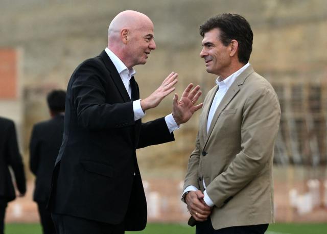 FIFA President Gianni Infantino (L) speaks with Bolivia's president-elect Rodrigo Paz during his visit to the country to inaugurate the first phase of the Bolivian national team's High-Performance Center, known as "La Casa de la Verde," in La Paz on October 20, 2025. (Photo by Roberto ARANDA / AFP)