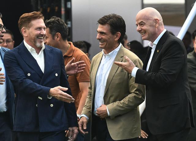 FIFA President Gianni Infantino (R) gestures next to Bolivia's president-elect Rodrigo Paz (C) and CONMEBOL President Alejandro Dominguez during his visit to the country to inaugurate the first phase of the Bolivian national team's High-Performance Center, known as "La Casa de la Verde," in La Paz on October 20, 2025. (Photo by Roberto ARANDA / AFP)