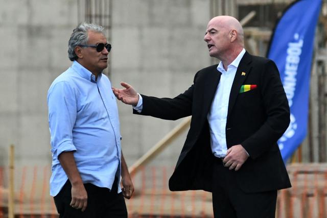 FIFA President Gianni Infantino (R) speaks with former Bolivian footballer Marco Echeverry during his visit to the country to inaugurate the first phase of the Bolivian national team's High-Performance Center, known as "La Casa de la Verde," in La Paz on October 20, 2025. (Photo by Roberto ARANDA / AFP)
