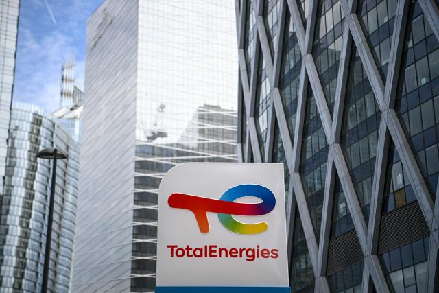(FILES) This photograph taken on May 28, 2021 shows the new TotalEnergies logo during its unveling ceremony, at a charging station in La Defense on the outskirts of Paris. Paris courthouse will deliver on October 23, 2025 his decision on the appeal for "misleading commercial practices" filed by three NGOs accusing TotalEnergies of 2greenwashing". (Photo by Christophe ARCHAMBAULT / AFP)