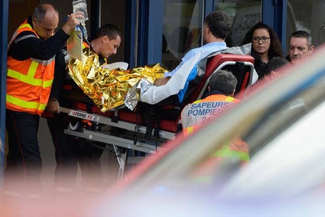 (FILES) (FILES) In this file photograph taken on October 23, 2015 firemen carry on a stretcher a man injured in a coach accident in Puisseguin, near Libourne, southwestern France. A tribute ceremony dedicated to the 43 victims will take place on October 23, 2025, ten years after the bus accident in Puisseguin, as the criminal proceeding has come to a standstill. (Photo by JEAN-PIERRE MULLER / AFP)