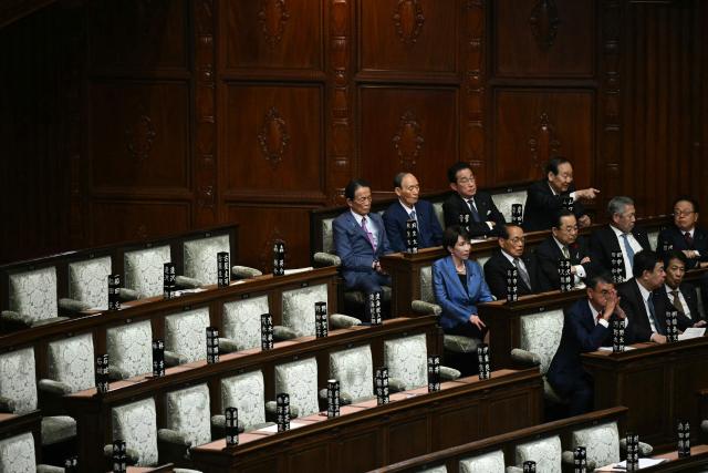 Liberal Democratic Party (LDP) President Sanae Takaichi (L, middle row) looks on during voting for Japan's new prime minister during an extraordinary session of the lower house of parliament in Tokyo on October 21, 2025.  (Photo by Philip FONG / AFP)