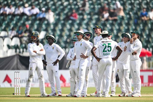 South Africa's players wait for the third umpire decision against Pakistan's Salman Agha (R) during the second day of the second Test cricket match between Pakistan and South Africa at the Rawalpindi Cricket Stadium in Rawalpindi on October 21, 2025. (Photo by Aamir QURESHI / AFP)