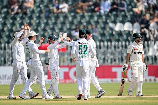 South Africa's players celebrate after the dismissal of Pakistan's Salman Agha (R) during the second day of the second Test cricket match between Pakistan and South Africa at the Rawalpindi Cricket Stadium in Rawalpindi on October 21, 2025. (Photo by Aamir QURESHI / AFP)