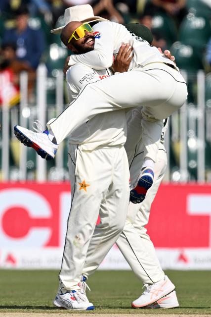 Pakistan's Sajid Khan (L) celebrates with teammate Salman Agha after taking the wicket of South Africa's captain Aiden Markram during the second day of the second Test cricket match between Pakistan and South Africa at the Rawalpindi Cricket Stadium in Rawalpindi on October 21, 2025. (Photo by Aamir QURESHI / AFP)